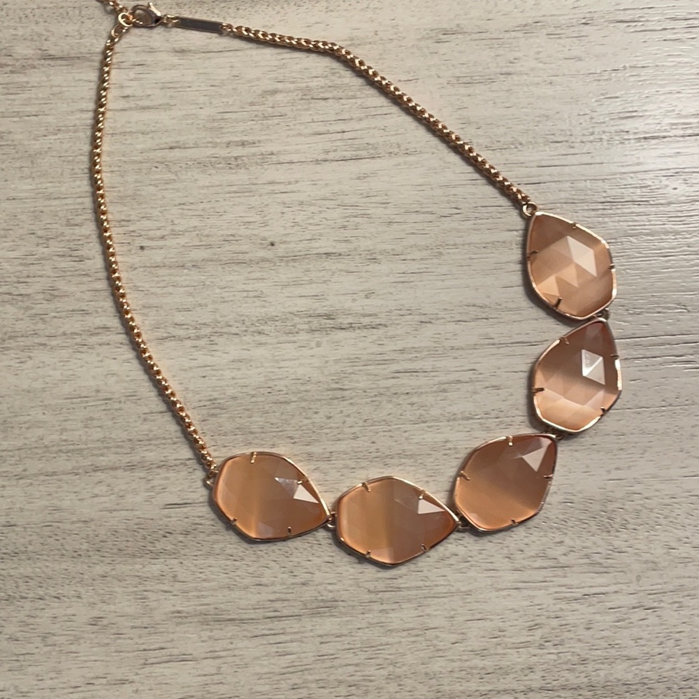 Five stone Kendra Scott peach colored necklace in rose gold